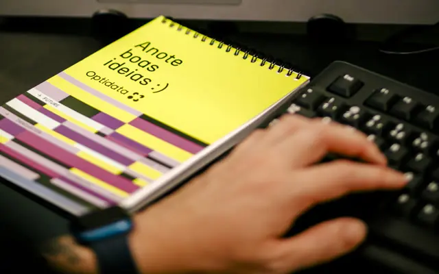 Optidata notebook beside a keyboard