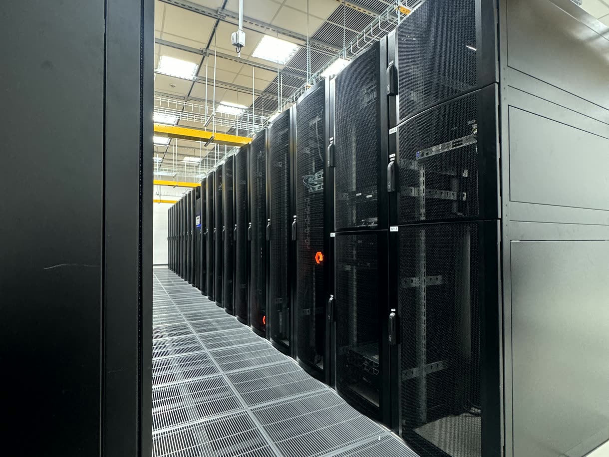 Aisle between server racks in a data center where Optidata operates