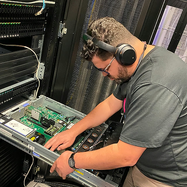 Optidata engineer installing components in a server